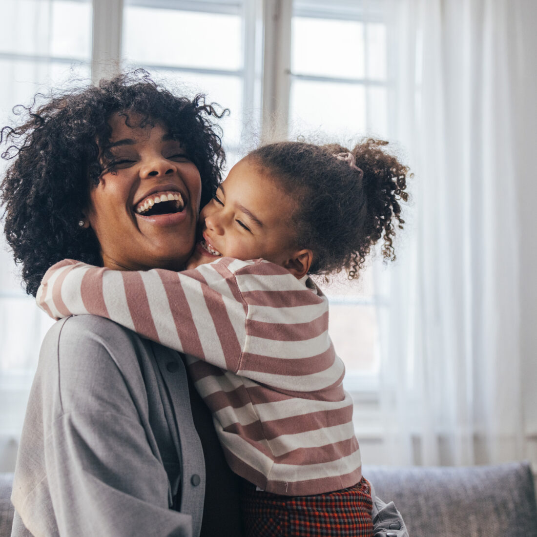 Sincere emotion: An adorable preschool child adores her nanny. They are both smiling.