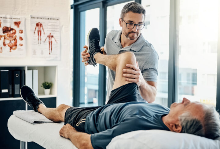 Shot of a friendly physiotherapist treating his mature patient in a rehabilitation center